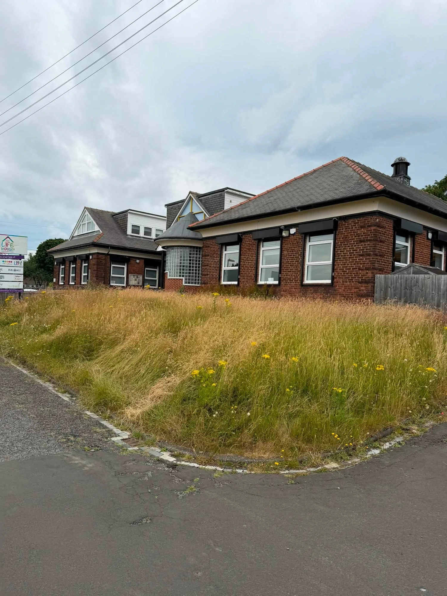 Overgrown frontage cut back — The Life House — before